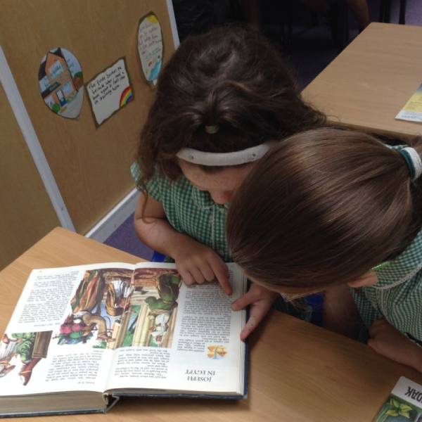 School Pupils Reading a Book